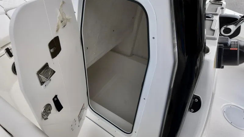 Slide: The Image of 2025 Sea Fox 228 Commander boat storage compartment with open door. - 25