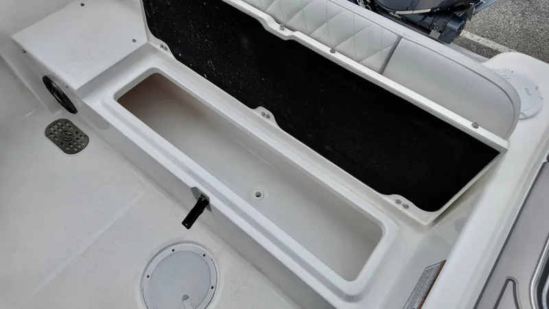 Slide: The Image of 2025 Sea Fox 228 Commander boat storage compartment with cushioned seating. - 29