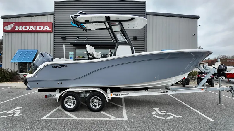 Slide: The Image of 2025 Sea Fox 228 Commander boat on trailer outside Honda dealership. - 3