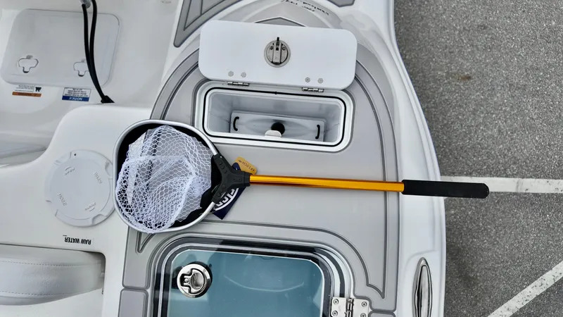 Slide: The Image of 2025 Sea Fox 228 Commander boat deck with fishing net and storage compartments. - 31