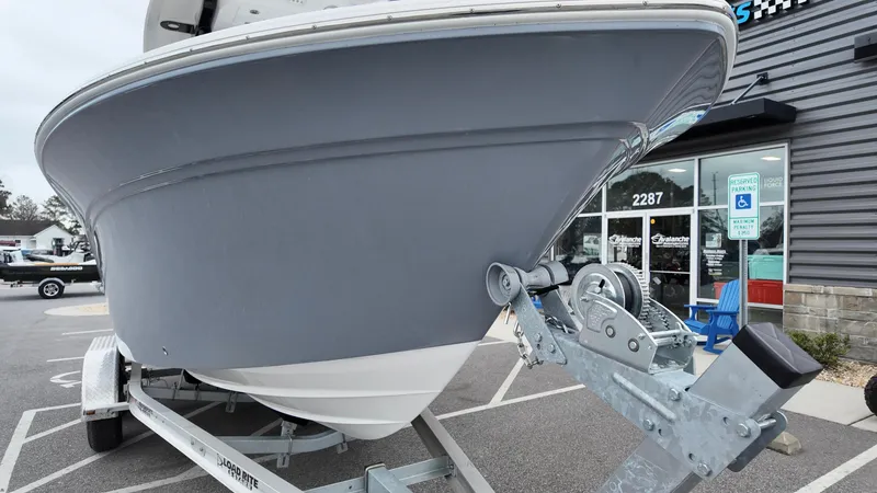 Slide: The Image of 2025 Sea Fox 228 Commander boat on trailer, parked outside a building. - 4