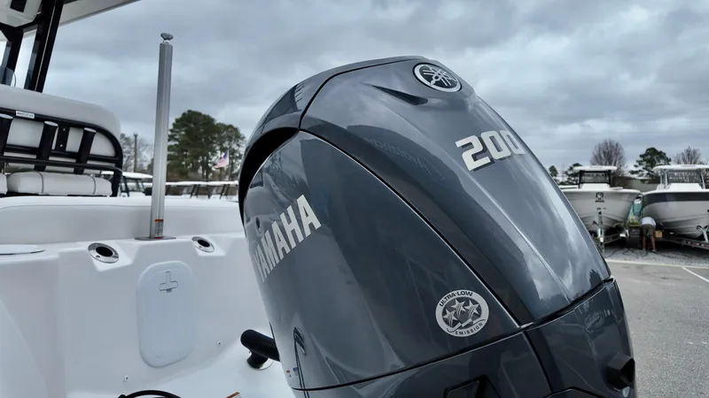 Slide: The Image of 2025 Sea Fox 228 Commander with Yamaha 200 engine, parked outdoors. - 7