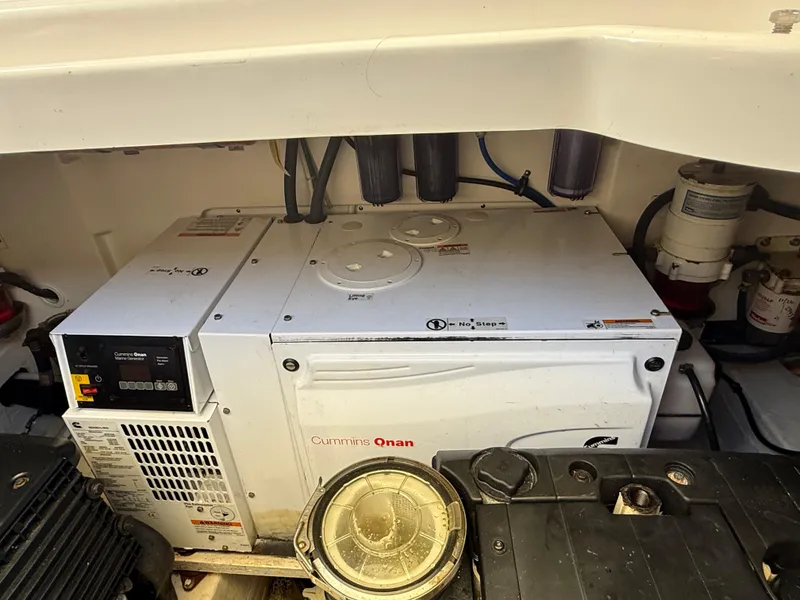 Slide: The Image of 2014 Tiara Yachts 4500 Sovran interior with beige seating and clear enclosure, city skyline view. - 12