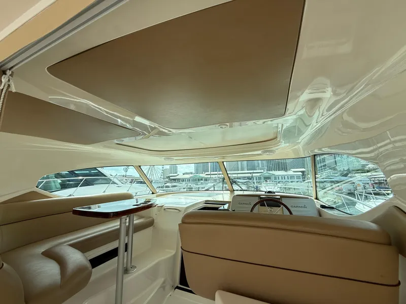 Slide: The Image of Interior view of 2014 Tiara Yachts 4500 Sovran, featuring a compact fridge and seating. - 18
