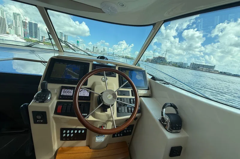 Slide: The Image of Interior of 2014 Tiara Yachts 4500 Sovran with elegant seating and polished table. - 23