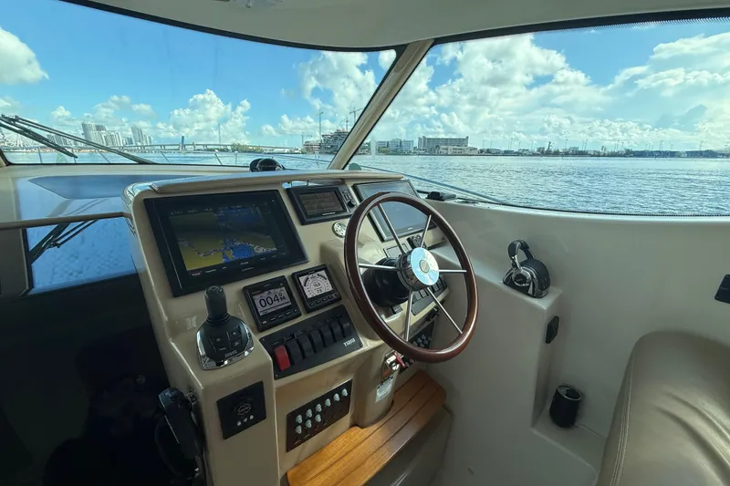 Slide: The Image of Helm of 2014 Tiara Yachts 4500 Sovran with city skyline view. - 24