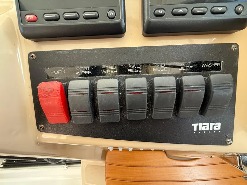 Slide: The Image of Helm of 2014 Tiara Yachts 4500 Sovran with advanced navigation controls and displays. - 34