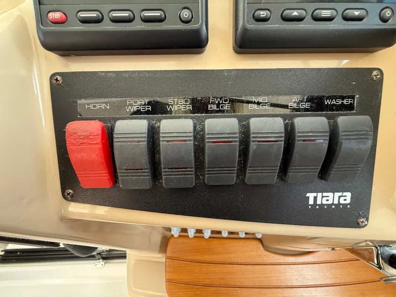 Slide: The Image of Control panel of a 2014 Tiara Yachts 4500 Sovran with navigation and throttle controls. - 36