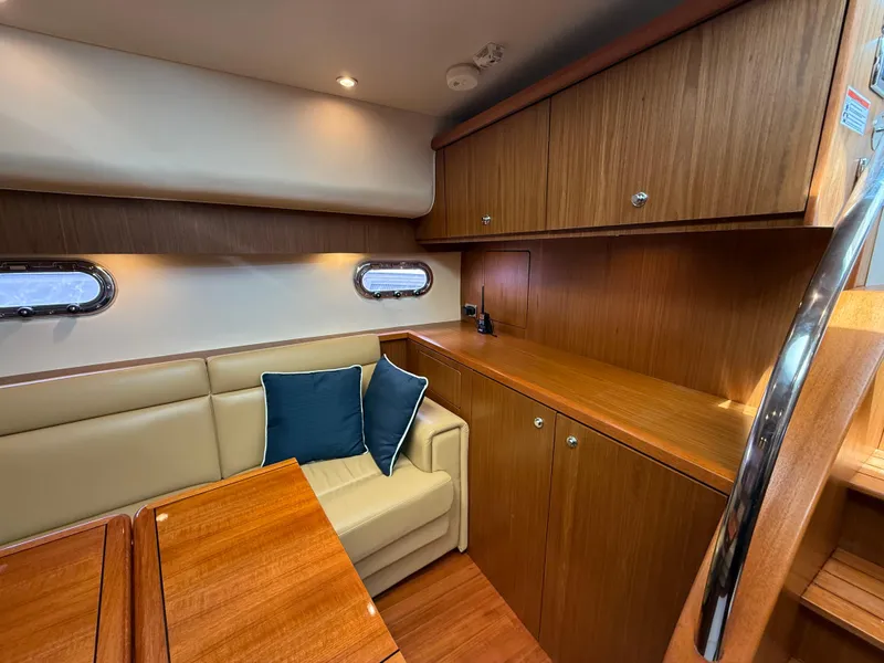 Slide: The Image of Luxurious interior of 2014 Tiara Yachts 4500 Sovran with elegant wood finishes and cozy seating. - 41