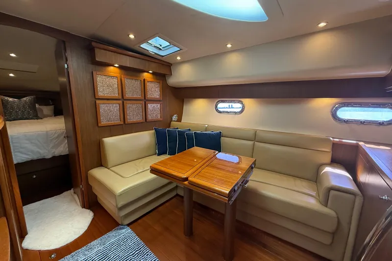 Slide: The Image of 2014 Tiara Yachts 4500 Sovran interior with wood cabinetry and beige seating. - 42