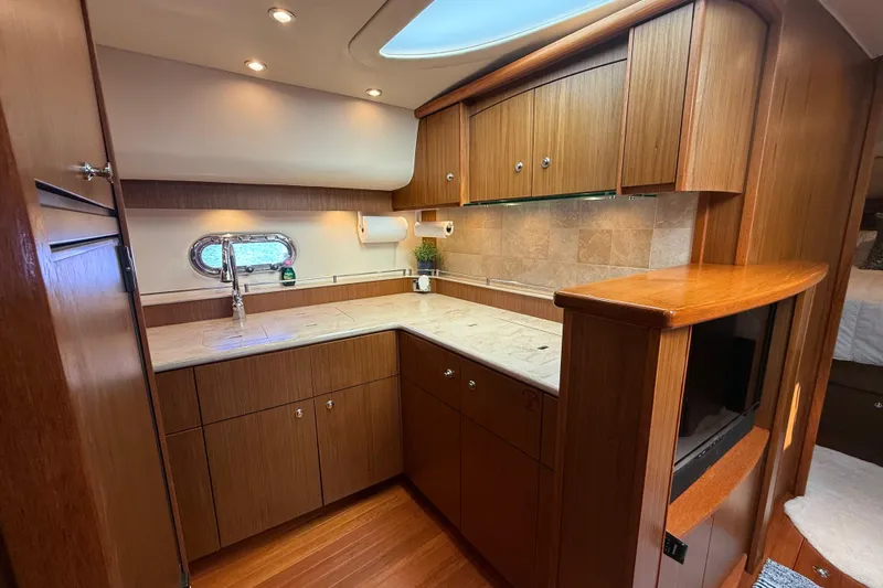 Slide: The Image of Interior of 2014 Tiara Yachts 4500 Sovran with wood cabinetry and TV. - 46