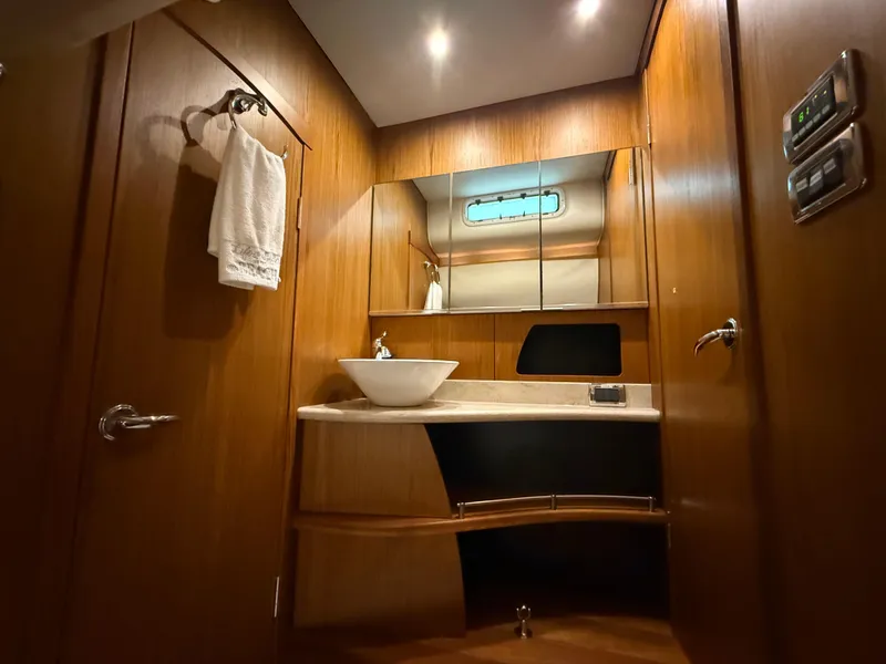 Slide: The Image of 2014 Tiara Yachts 4500 Sovran cabin with twin beds and wooden interior. - 54