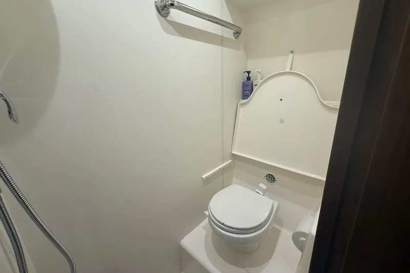 Slide: The Image of Luxurious bathroom interior of 2014 Tiara Yachts 4500 Sovran with wood finish. - 55