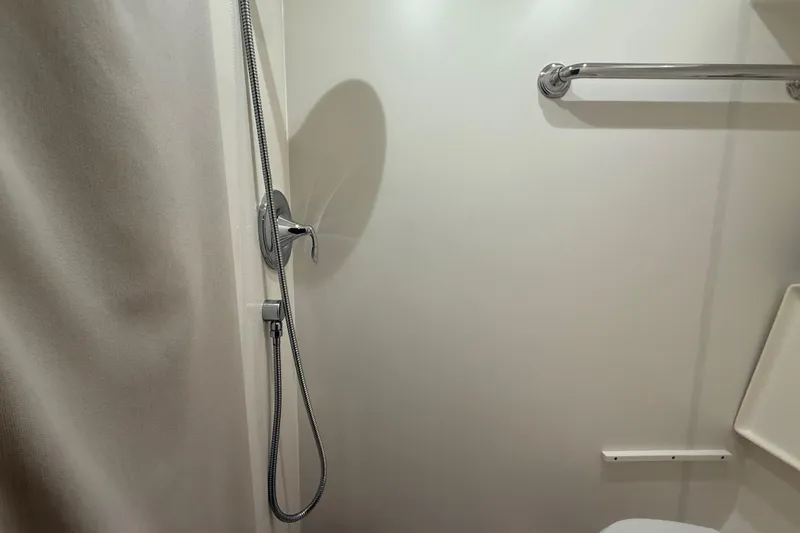 Slide: The Image of 2014 Tiara Yachts 4500 Sovran bathroom with toilet and shower amenities. - 56