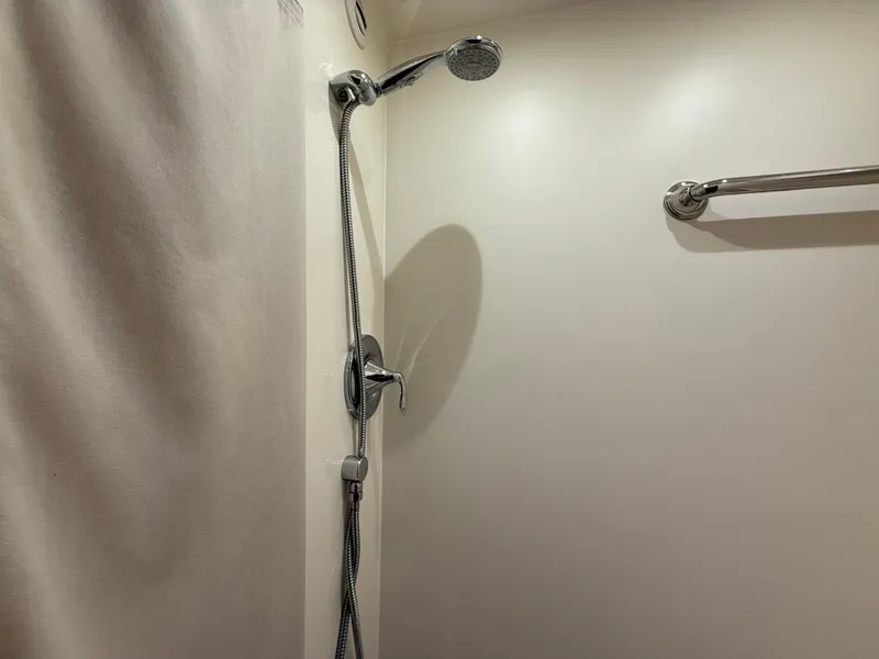 Slide: The Image of Shower area in 2014 Tiara Yachts 4500 Sovran, featuring chrome fixtures and towel bar. - 57