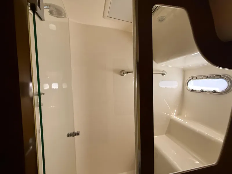 Slide: The Image of 2014 Tiara Yachts 4500 Sovran bathroom with modern fixtures and porthole window. - 62