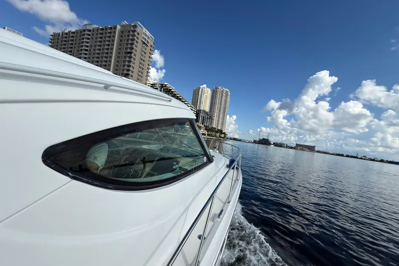 Slide: The Image of 2014 Tiara Yachts 4500 Sovran cruising on a sunny day with city skyline in view. - 64