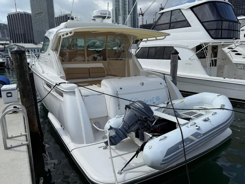 Slide: The Image of 2014 Tiara Yachts 4500 Sovran docked with inflatable boat attached. - 84