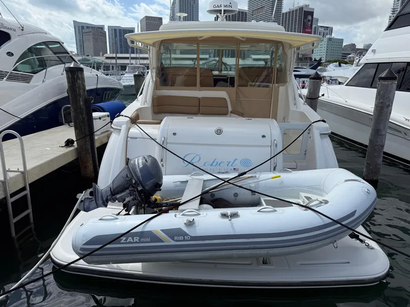 Slide: The Image of 2014 Tiara Yachts 4500 Sovran docked with inflatable boat on stern. - 85