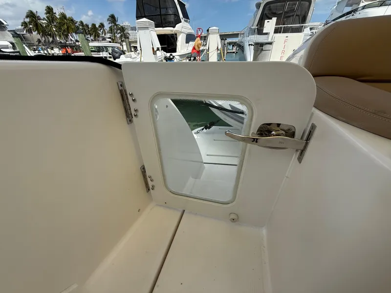 Slide: The Image of 2014 Tiara Yachts 4500 Sovran interior with tan seating, cruising on calm waters. - 9