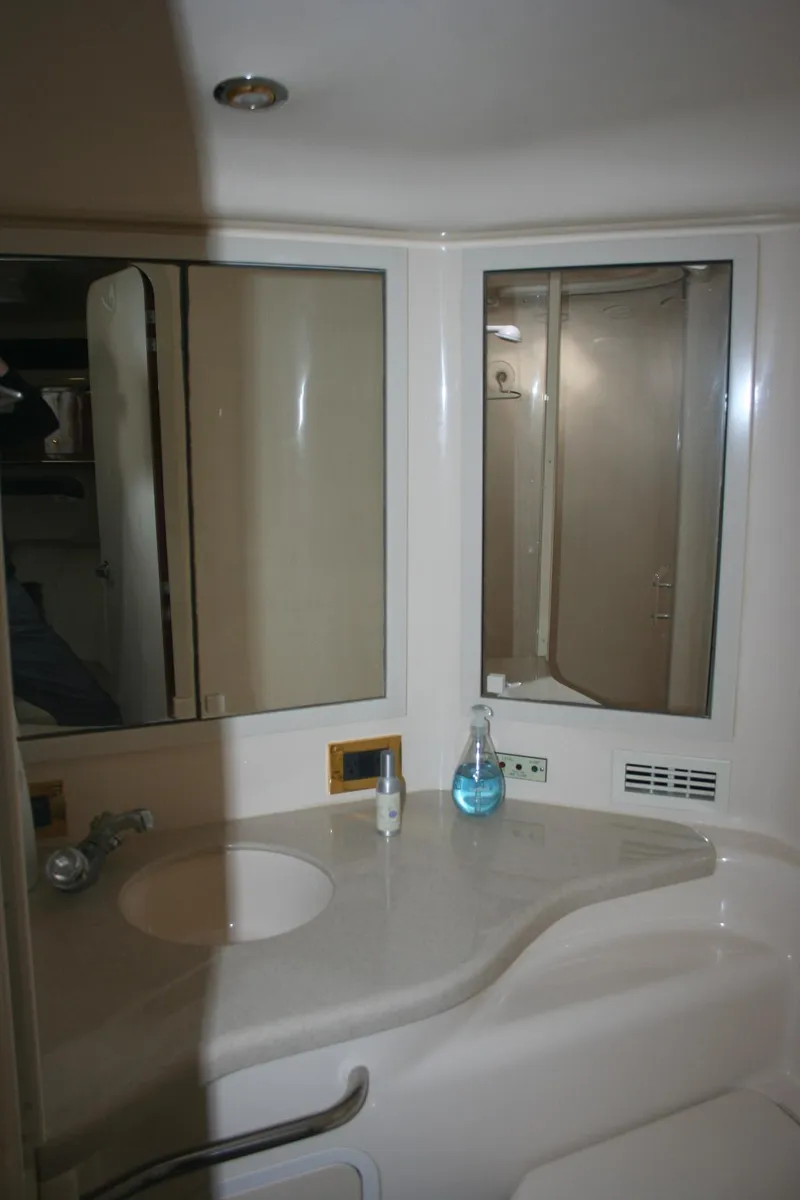 Slide: The Image of Interior of 1999 Sea Ray 400 Sundancer yacht with white leather seating. - 10