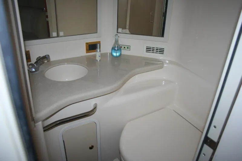 Slide: The Image of 1999 Sea Ray 400 Sundancer yacht interior with wooden cabinetry and modern kitchen amenities. - 11