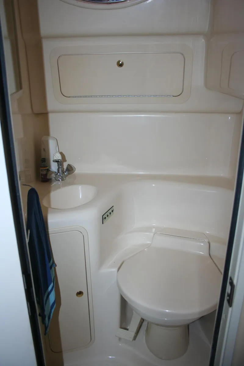 Slide: The Image of Interior cabin of a 1999 Sea Ray 400 Sundancer with plush seating and bedding. - 20