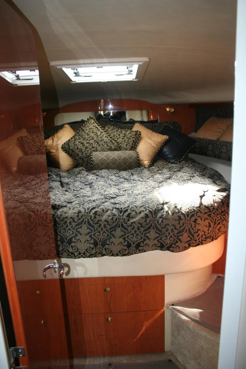 Slide: The Image of Luxurious cabin interior of 1999 Sea Ray 400 Sundancer with elegant bedding and cushions. - 3