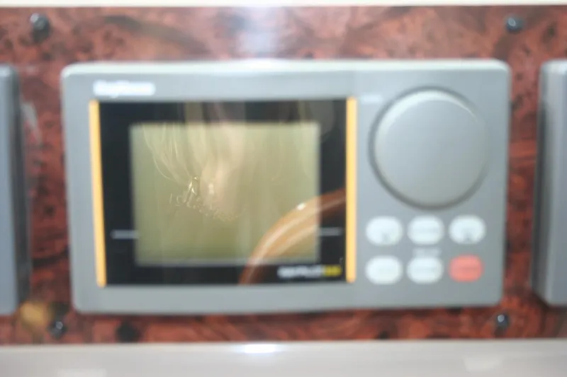 Slide: The Image of Close-up of a 1999 Sea Ray 400 Sundancer boat component with metallic detailing. - 33