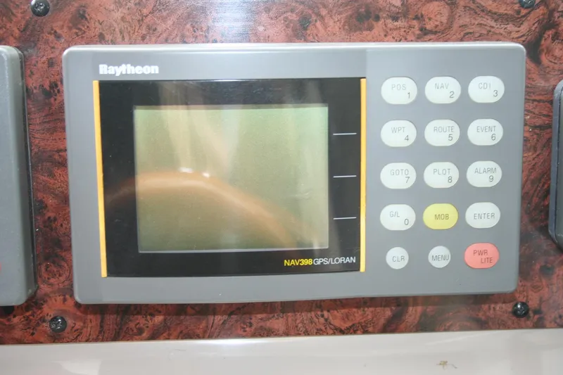 Slide: The Image of 1999 Sea Ray 400 Sundancer cockpit with white captain's chair and control panel. - 34