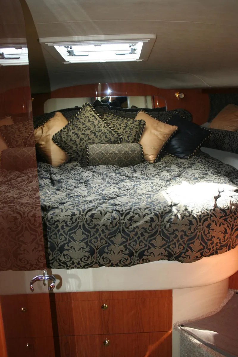 Slide: The Image of Interior of 1999 Sea Ray 400 Sundancer with TV and patterned upholstery. - 4