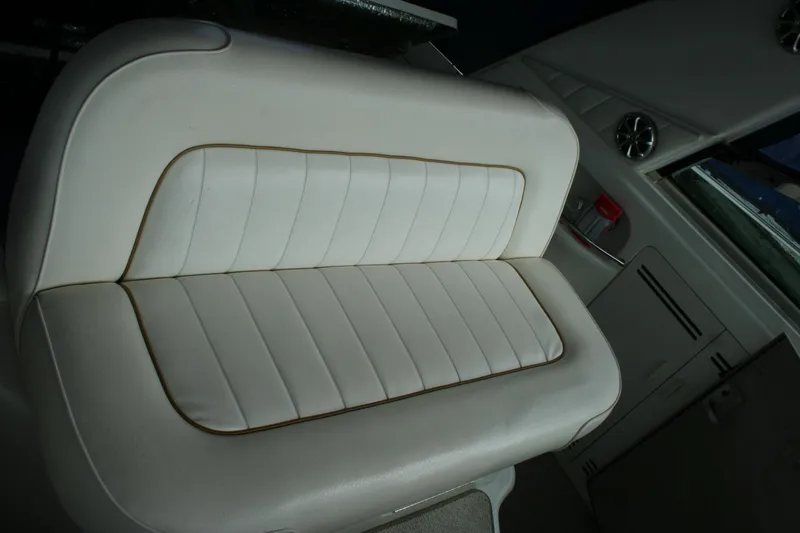 Slide: The Image of 1999 Sea Ray 400 Sundancer interior with white seating and table, blue canopy. - 40