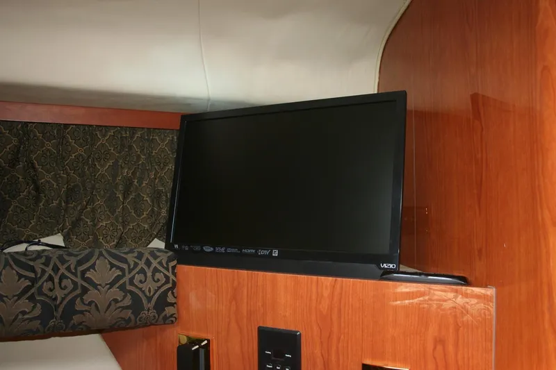 Slide: The Image of Luxurious cabin interior of 1999 Sea Ray 400 Sundancer with elegant bedding and mirror. - 5