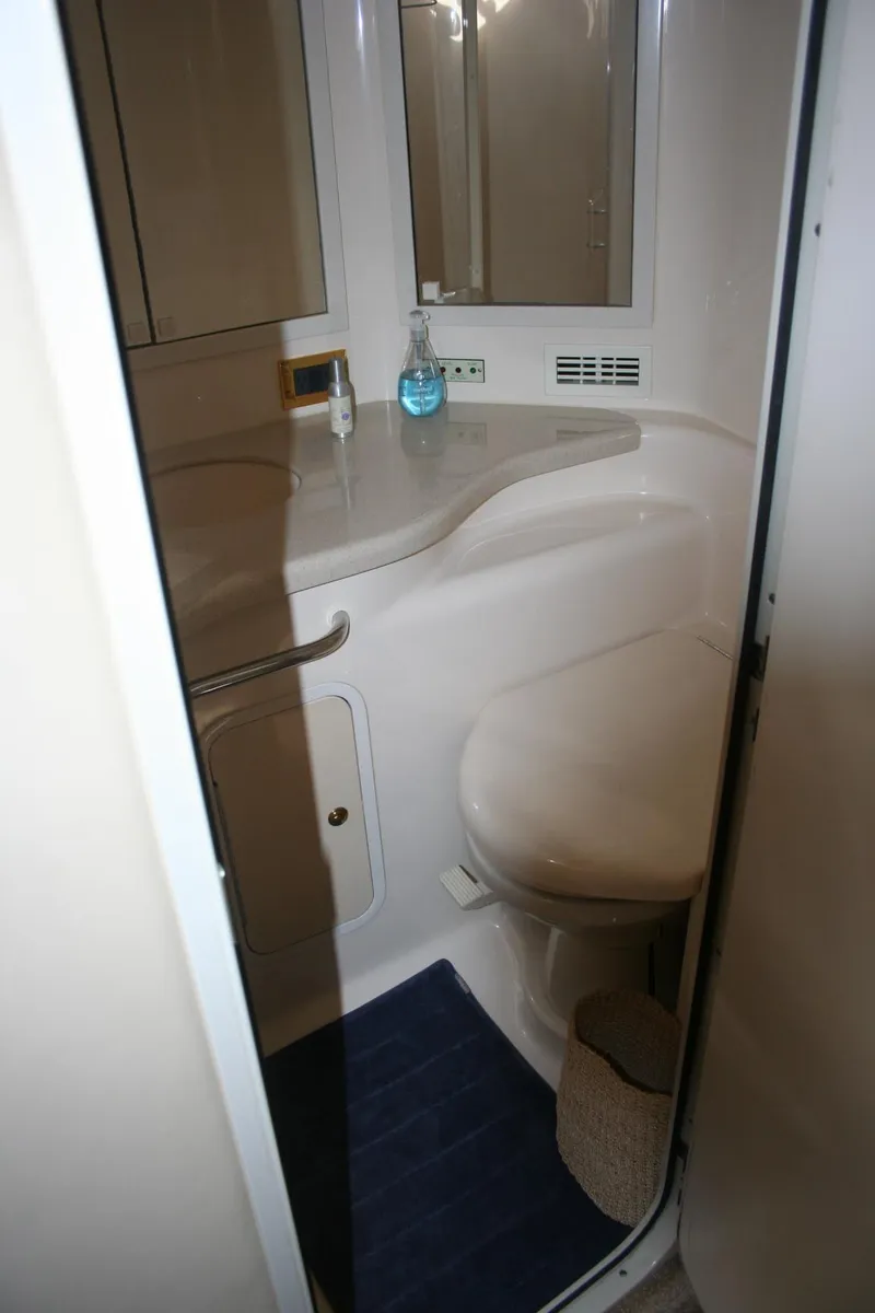 Slide: The Image of Bathroom interior of 1999 Sea Ray 400 Sundancer yacht, featuring sink and mirror. - 8