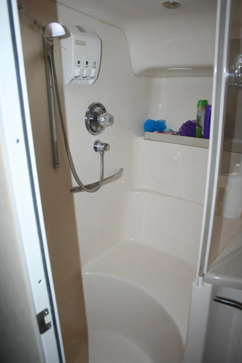 Slide: The Image of 1999 Sea Ray 400 Sundancer bathroom with sink, mirror, and toilet. - 9