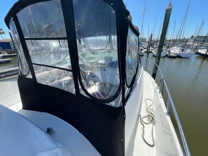 Slide: The Image of 2000 Carver 350 Mariner yacht docked at marina, featuring enclosed cockpit and clear windows. - 11