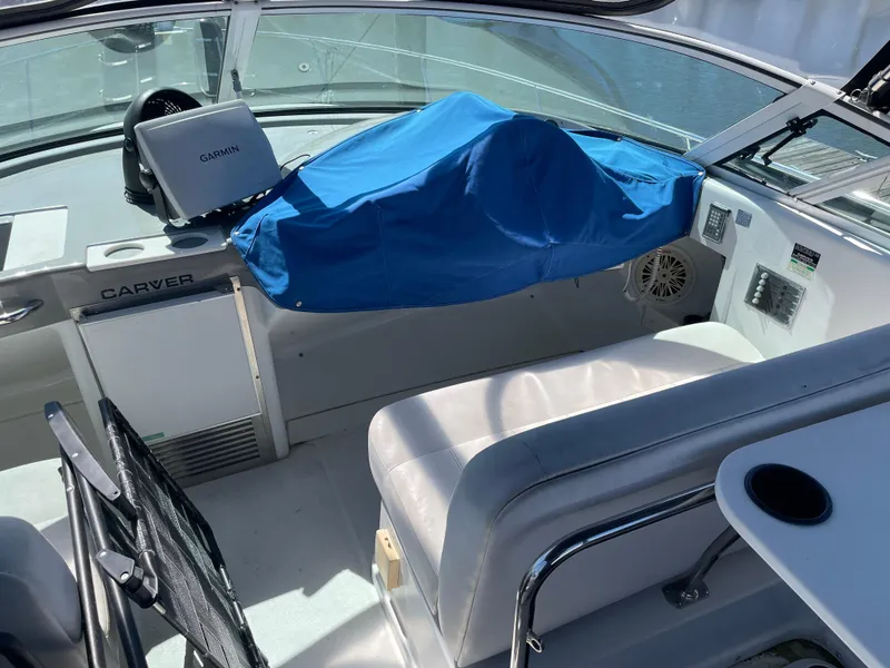 Slide: The Image of Interior view of a 2000 Carver 350 Mariner boat cockpit with covered controls. - 12