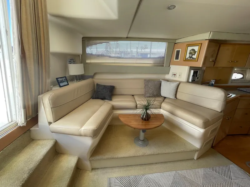 Slide: The Image of Interior of 2000 Carver 350 Mariner yacht with modern seating and entertainment area. - 22