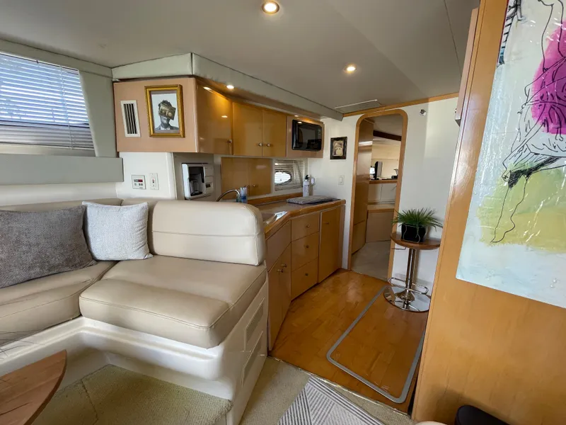 Slide: The Image of Interior of 2000 Carver 350 Mariner yacht with modern seating and kitchenette. - 34