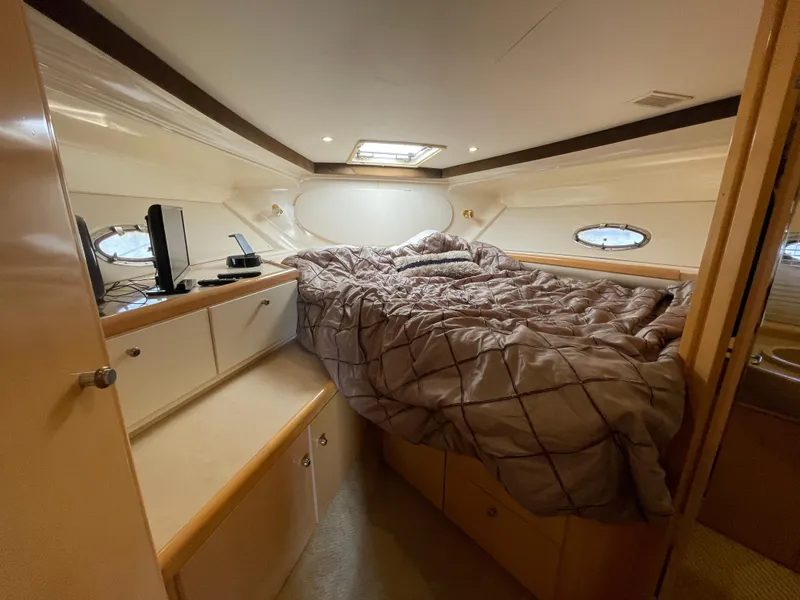 Slide: The Image of Engine compartment of a 2000 Carver 350 Mariner boat, featuring mechanical components. - 35