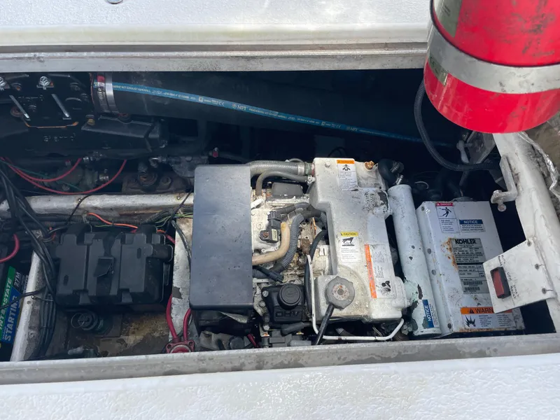 Slide: The Image of Engine compartment of a 2000 Carver 350 Mariner boat, showing various components and wiring. - 37