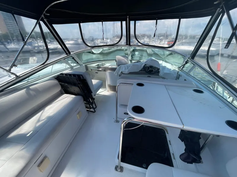 Slide: The Image of 2000 Carver 350 Mariner boat interior with seating and table, featuring a spacious cockpit area. - 8