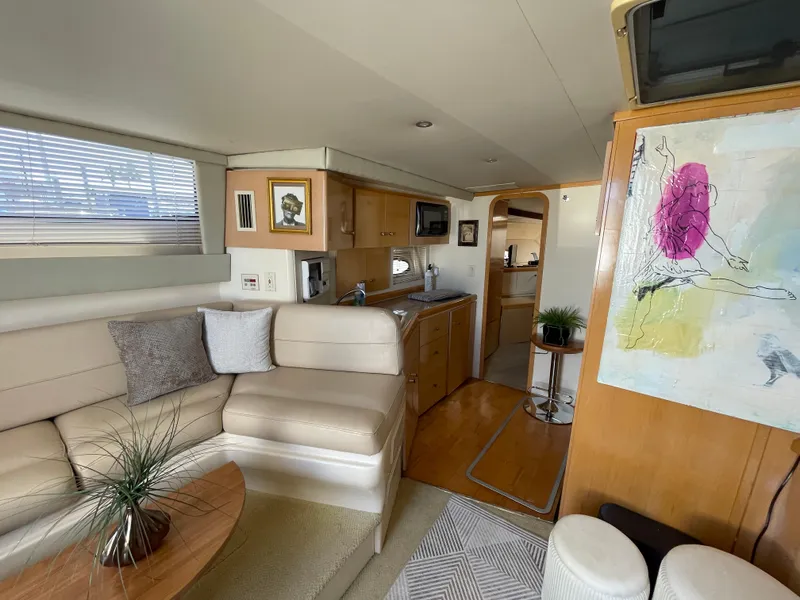 Slide: The Image of Interior of 2000 Carver 350 Mariner yacht with beige seating and modern amenities. - 23