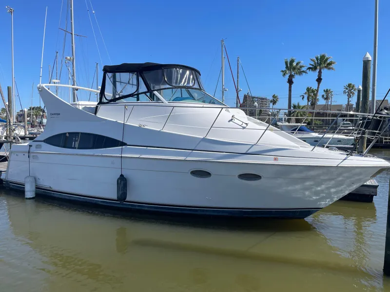 Slide: The Image of 2000 Carver 350 Mariner yacht docked at marina under clear blue sky. - 4