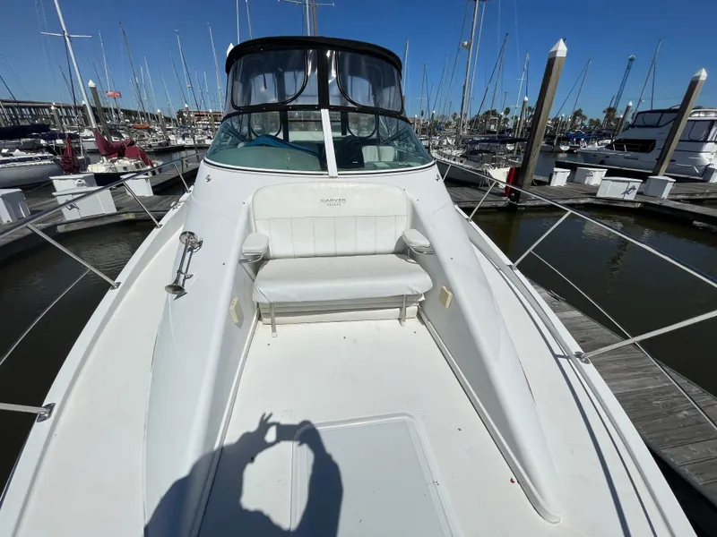 Slide: The Image of 2000 Carver 350 Mariner boat docked at marina, featuring spacious deck seating. - 9