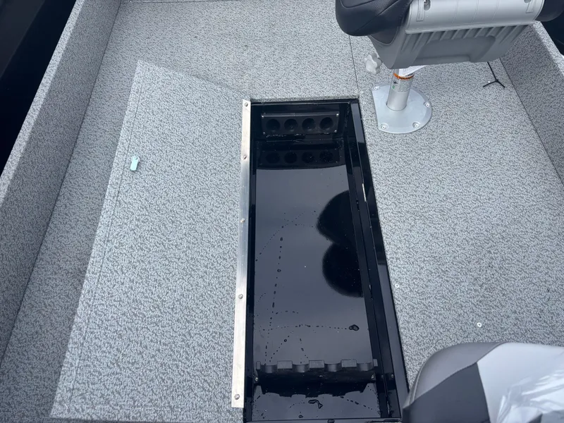 Slide: The Image of 2025 Crestliner 1650 Discovery Tiller boat interior with open storage compartment. - 2