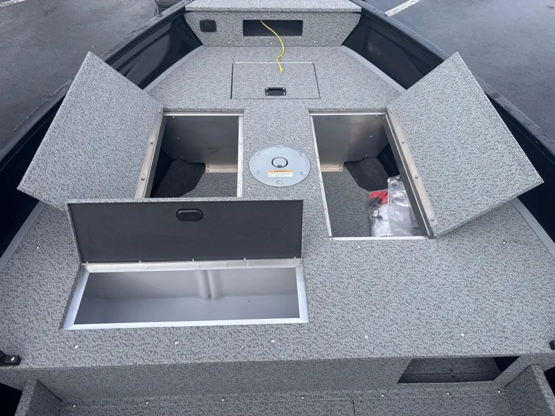 Slide: The Image of 2025 Crestliner 1650 Discovery Tiller boat with open storage compartments. - 3