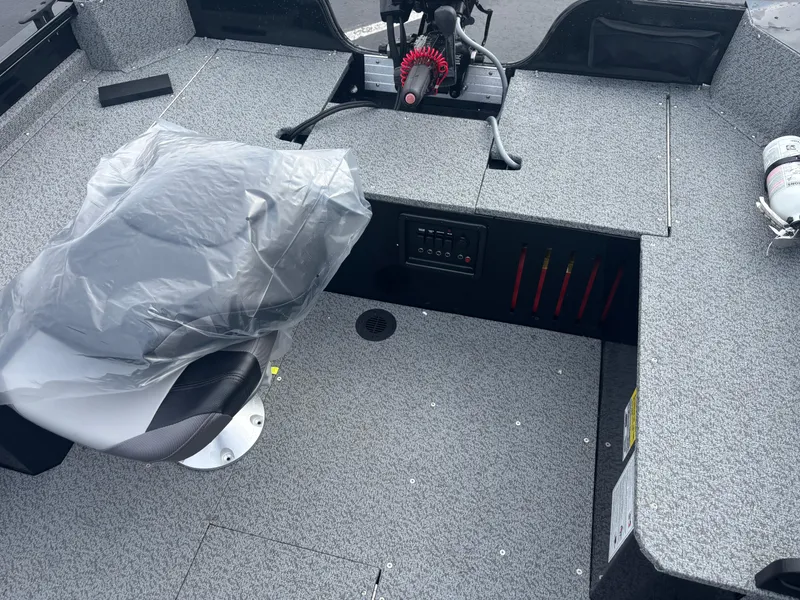 Slide: The Image of 2025 Crestliner 1650 Discovery Tiller boat interior with covered seat and control panel. - 4