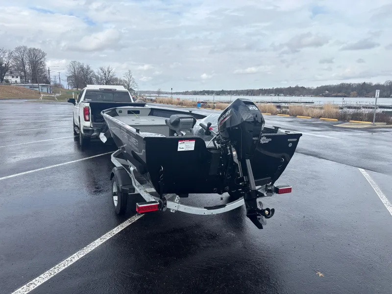 Slide: The Image of 2025 Crestliner 1650 Discovery Tiller boat on trailer in parking lot. - 7