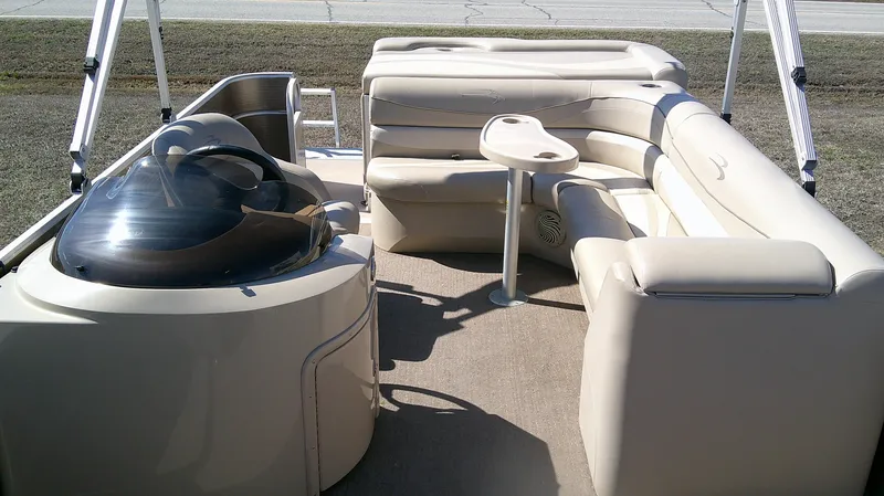 Slide: The Image of 2011 Bennington 2571 GLi pontoon boat interior with beige seating and helm. - 5